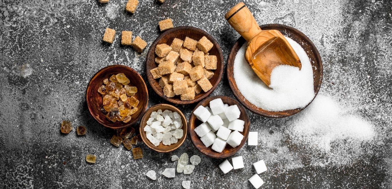 When Things are Hard, Accountability & Friends Pull You Through Quitting Sugar. Five bowls with different types of sugar and a wooden scoop.