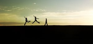 When You See Your Fitness as a Long-Game, Life Changes! Silhouette of a woman progressing through a jump with a sunset background.