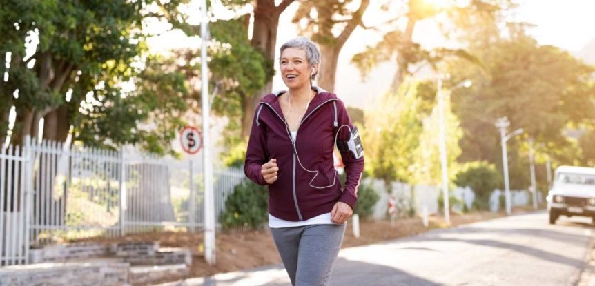 Do You Need to Change What You're Doing for your Fitness. Woman in maroon hoody jogging.