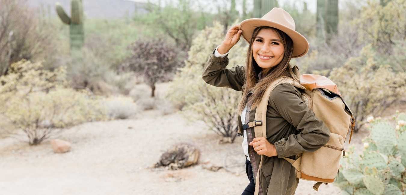 Saying Yes to Adventure When You Should (probably) Say No. Woman hiking and smiling.