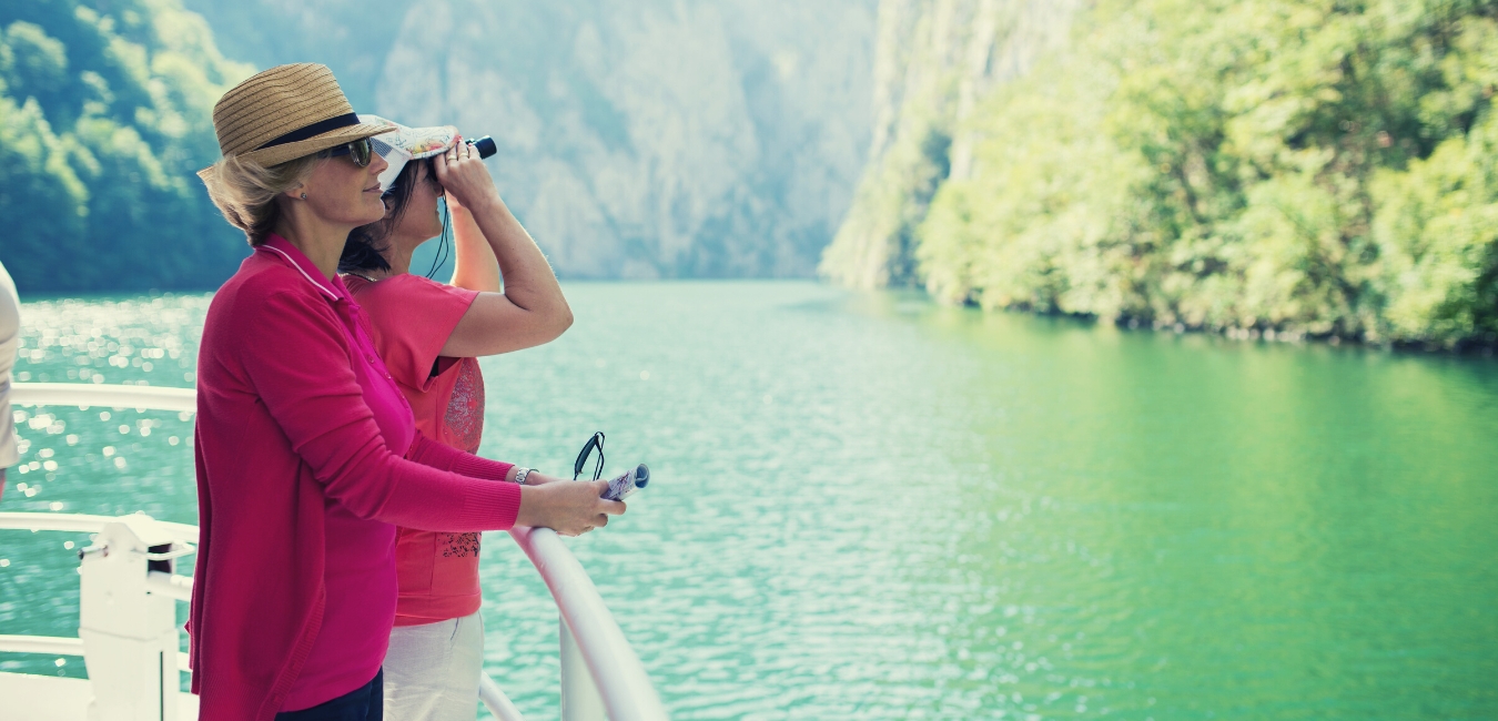 In a Rush? What 'Your Hurry' Might be Telling You About Your Fitness, fit is freedom header image, woman in the mountains looking through binoculars.